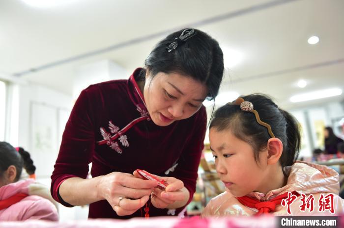 江西省級非遺豫章繡傳承人手把手指導(dǎo)小學(xué)生繡制2022年北京冬奧會吉祥物“冰墩墩”形象?！∮髟屏?攝