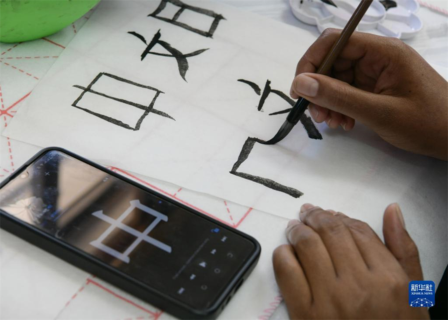 4月18日，肯尼亞學(xué)生在內(nèi)羅畢大學(xué)孔子學(xué)院舉辦的活動(dòng)上寫毛筆字。肯尼亞內(nèi)羅畢大學(xué)孔子學(xué)院18日舉辦“中文，增進(jìn)文明對(duì)話”主題活動(dòng)，慶祝即將到來的第14個(gè)聯(lián)合國中文日。肯尼亞學(xué)生參與互動(dòng)，進(jìn)行書法、剪紙、唱中文歌等活動(dòng)。新華社記者 韓旭 攝